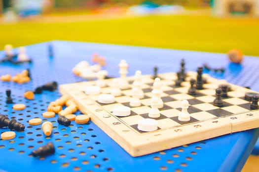 Scattered chess summer day on the blue table in the Park