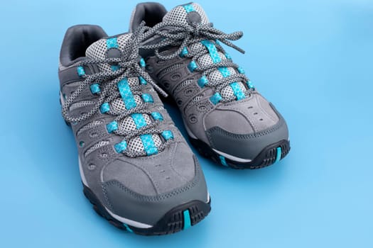 Hiking Male Trekking Footwear, Waterproof Non Slip Mountain Shoes, Adventurer Boots on Blue Background, Heavy-duty Tread Outsole. Man's Durable Synthetic Leather Outdoor Outfit For Sport.