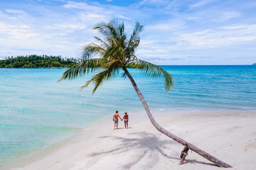 Tropical Island Koh Kood or Koh Kut Thailand. Couple men and women on vacation in Thailand walking at the beach in Eastern Thailand Trang