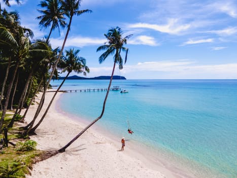 Tropical Island Koh Kood or Koh Kut Thailand. Couple men and women on vacation in Thailand walking at the beach in Eastern Thailand Trang