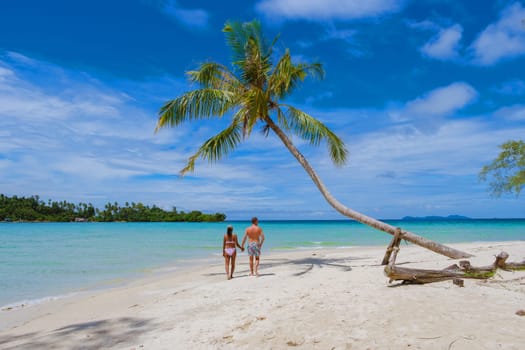 Tropical Island Koh Kood or Koh Kut Thailand. Couple men and women on vacation in Thailand walking at the beach