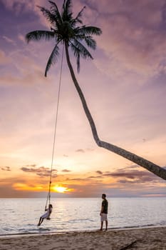 Tropical Island Koh Kood or Koh Kut Thailand. Couple men and women on vacation in Thailand walking at the beach, holiday concept Island hopping in Eastern Thailand Trang, couple with a rope swing