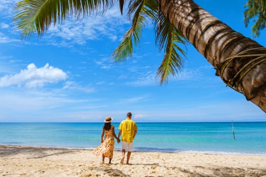 Tropical Island Koh Kood Thailand. Couple men and women on vacation in Thailand walking at the beach, holiday concept Island hopping in Eastern Thailand Trang