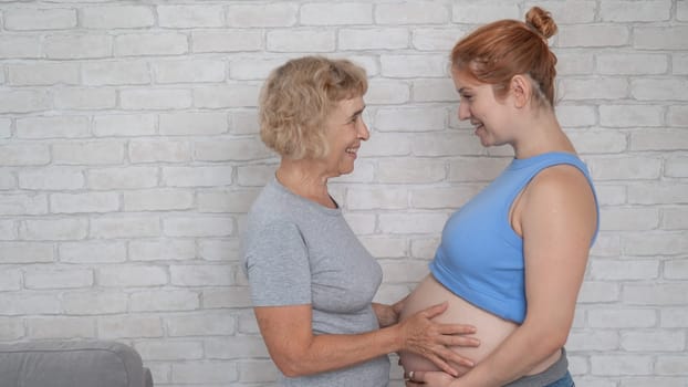 Elderly woman and her adult pregnant daughter