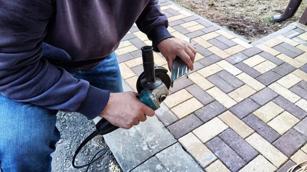 Man working with electric grinder tool on Steel beam. Electric grinding. Remove rust. Cutting of metal beam