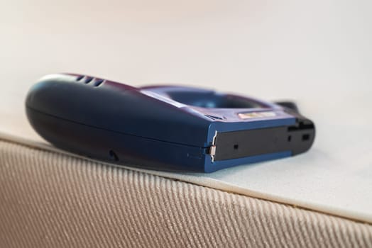 Worker stapling sofa lining with electric staple gun