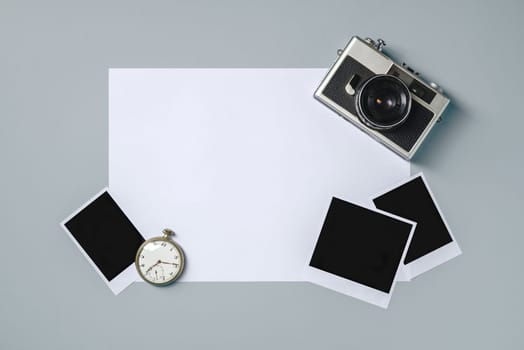 Vintage photo camera and empty photo frames on grey background. Travel moment concept