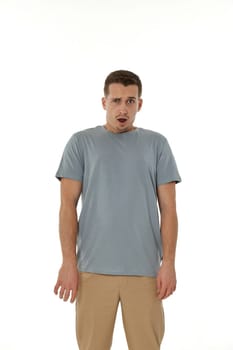 surprised guy looking at camera on white studio background