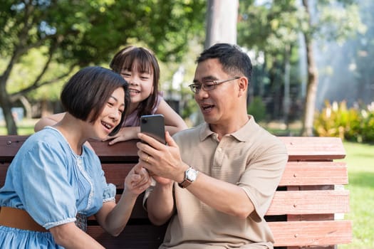 Grandparent enjoy with granddaughter in park surrounded with greenery and serenity. having joyful and cheerful time together in lush green environment. Loads of smile and happy moments.