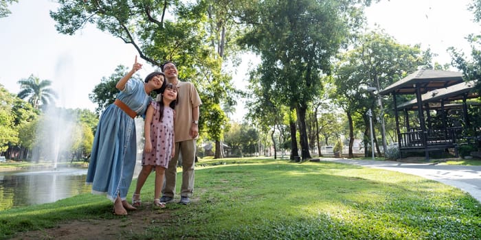 Grandparent enjoy with granddaughter in park surrounded with greenery and serenity. having joyful and cheerful time together in lush green environment. Loads of smile and happy moments.