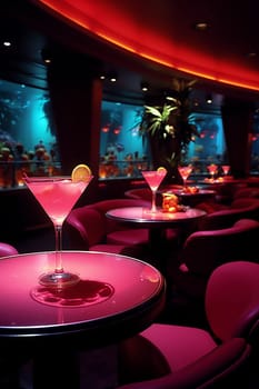 Elegant cocktail glasses on tables with moody red lighting in a modern lounge bar, club or nightclub, night life pink and red lights