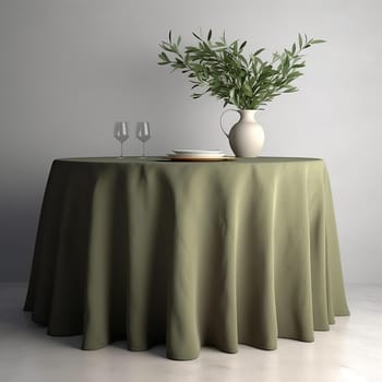 Elegant dining setup with green tablecloth, two wine glasses, plates, and a vase with green leaves on a simple background.