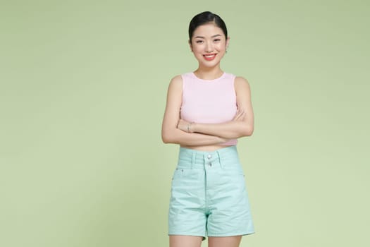 Photo of dreamy confident young woman looking empty space arms crossed smiling