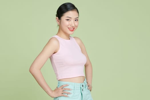 Portrait smiling young asian woman with arms akimbo
