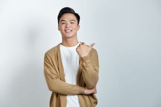 Happy man makes a gesture thumb up, portrait on white background