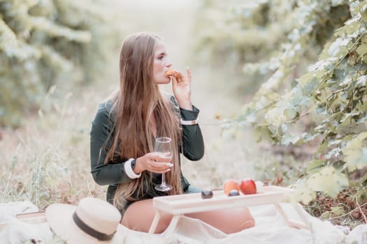 Picnic and wine tasting at sunset in the hills of Italy, Tuscany. Vineyards and open nature in the summer. Romantic dinner, fruit and wine.