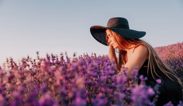 Close up portrait of young beautiful woman in a white dress and a hat is walking in the lavender field and smelling lavender bouquet.