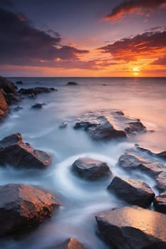 Beautiful sunset over the sea. Seascape. Long exposure.Beautiful seascape at sunset. Dramatic sky over the sea.Beautiful colorful sunset at the beach.Long exposure of sunset over the sea with rocks and colorful sky.Seascape with rocks and water