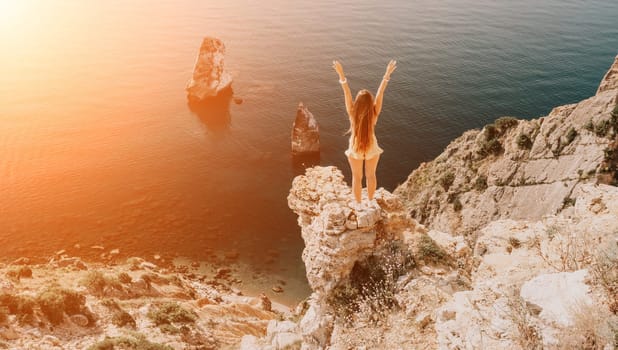 Woman travel sea. Happy tourist taking picture outdoors for memories. Woman traveler looks at the edge of the cliff on the sea bay of mountains, sharing travel adventure journey.