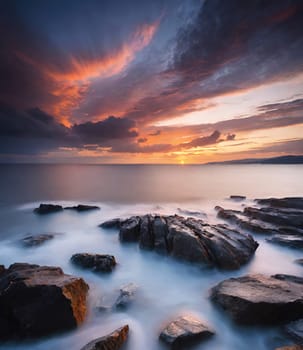 Beautiful sunset over the sea. Seascape. Long exposure.Beautiful seascape at sunset. Dramatic sky over the sea.Beautiful colorful sunset at the beach.Long exposure of sunset over the sea with rocks and colorful sky.Seascape with rocks and water