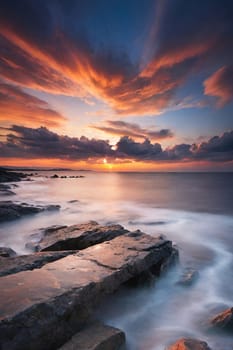 Beautiful sunset over the sea. Seascape. Long exposure.Beautiful seascape at sunset. Dramatic sky over the sea.Beautiful colorful sunset at the beach.Long exposure of sunset over the sea with rocks and colorful sky.Seascape with rocks and water