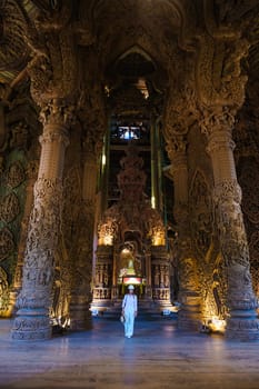 Asian Thai women visit The Sanctuary of Truth wooden temple in Pattaya Thailand