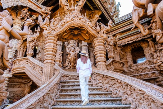 Asian Thai women visit The Sanctuary of Truth wooden temple in Pattaya Thailand