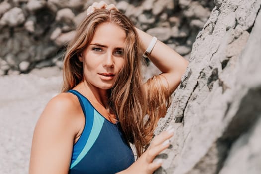 Woman travel sea. Young Happy woman in a long red dress posing on a beach near the sea on background of volcanic rocks, like in Iceland, sharing travel adventure journey