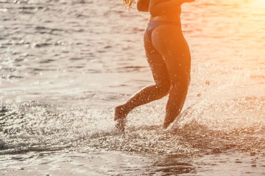 Running woman. Female runner jogging during the sunrise on beach. Woman Runner feet running on the beach at sunrise. woman fitness sunrise jog workout wellness concept.