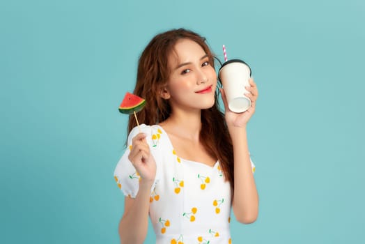 Young woman drinking watermelon juice on blue banner