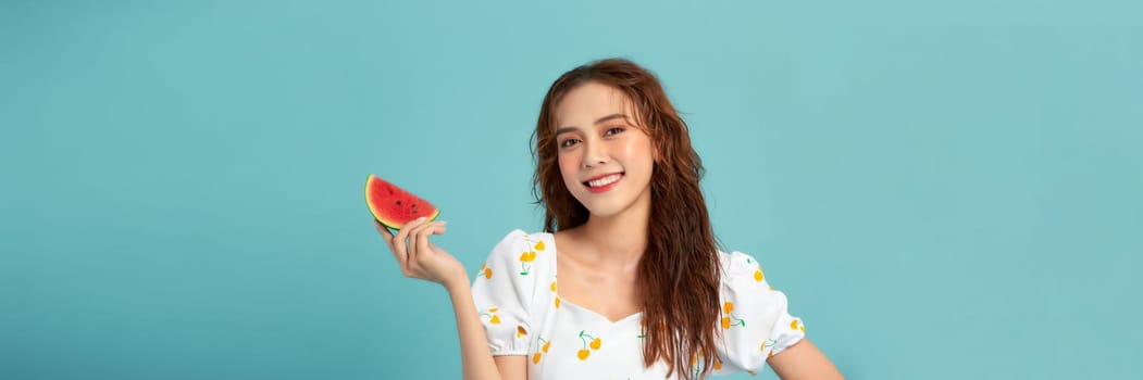 Beautiful happy young woman with fresh watermelon on blue background. Panorama