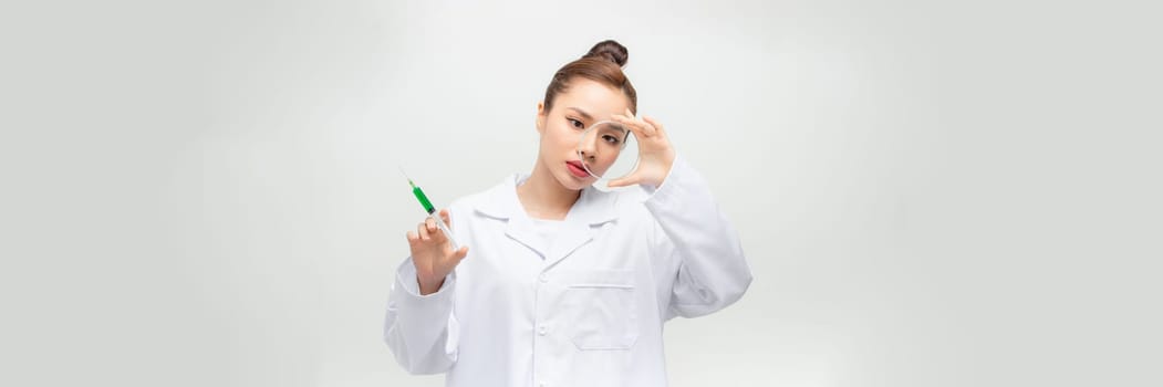 Woman holding a petri dish and a syringe, doctor.