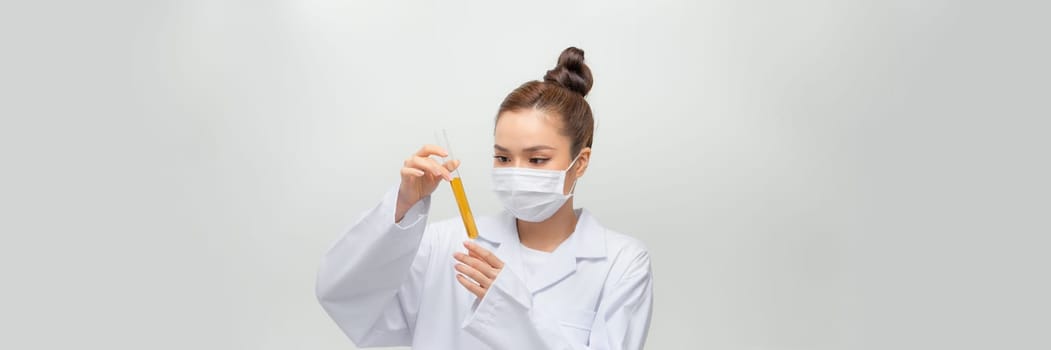 Female scientist in lab coat with chemical glassware. Isolated on white.