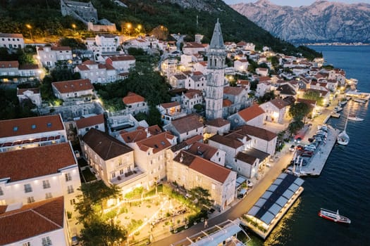 Courtyard of an ancient house in Perast, illuminated with garlands. Montenegro. Top view. High quality photo