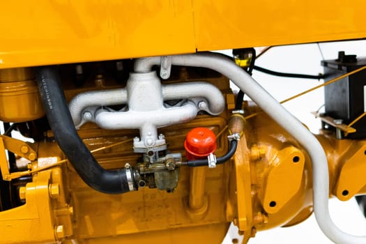 Small yellow tractor in an exhibition, closeup details, wheels