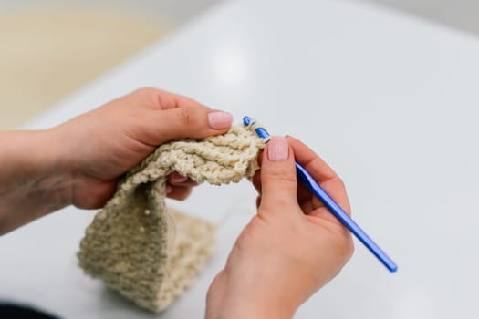 Process of a knitting isolated on white, female hands