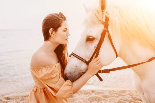 A woman in a dress stands next to a white horse on a beach, with the blue sky and sea in the background