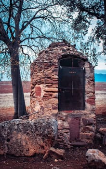 View of stone barn and in open field on morning. Small village in Catalonia photo. Red old stones texture background. High quality picture for wallpaper, article