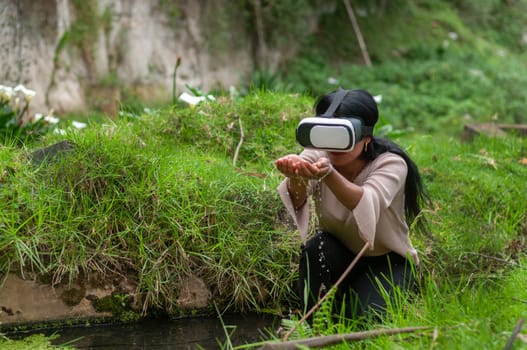 copyspace of a girl with augmented reality glasses looking at the water of a river and its properties.water day. High quality photo