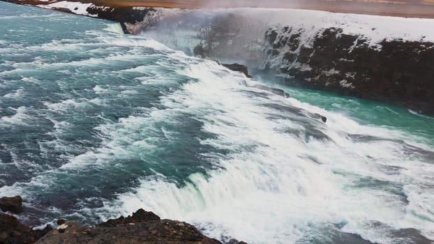 Beautiful water stream iceland nature with snowy fields and mountains, gullfoss waterfall in reykjavik. Majestic river flow in wilderness with scandinavian landscapes and cliffs, spectacular scenery.