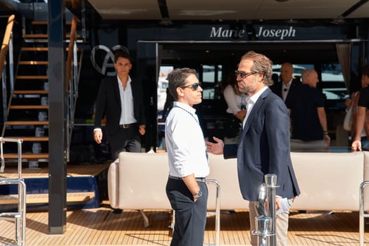 Monaco, Monte Carlo, 29 September 2022 - a lot of people, clients and yacht brokers look at the mega yachts presented, discuss the novelties of the boating industry at the famous motorboat exhibition. High quality photo