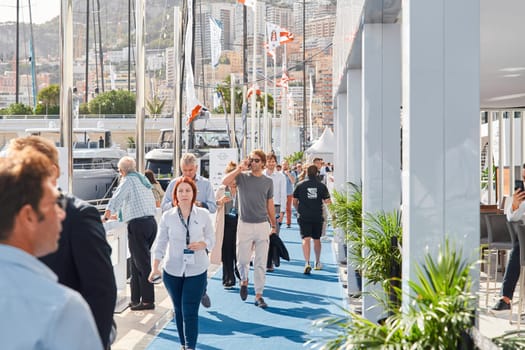 Monaco, Monte Carlo, 29 September 2022 - a lot of people, clients and yacht brokers look at the mega yachts presented, discuss the novelties of the boating industry at the famous motorboat exhibition. High quality photo