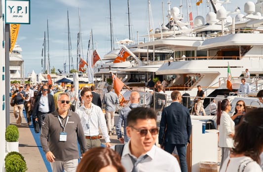 Monaco, Monte Carlo, 29 September 2022 - a lot of people, clients and yacht brokers look at the mega yachts presented, discuss the novelties of the boating industry at the famous motorboat exhibition. High quality photo