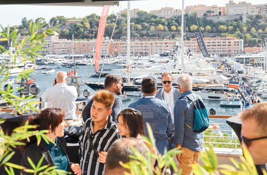 Monaco, Monte Carlo, 29 September 2022 - a lot of people, clients and yacht brokers look at the mega yachts presented, discuss the novelties of the boating industry at the famous motorboat exhibition. High quality photo