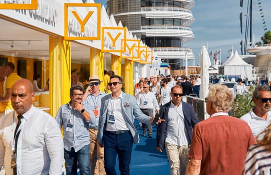 Monaco, Monte Carlo, 29 September 2022 - a lot of people, clients and yacht brokers look at the mega yachts presented, discuss the novelties of the boating industry at the famous motorboat exhibition. High quality photo