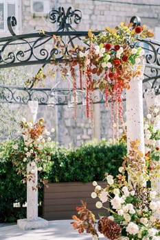 Column of a round rotunda decorated with red and white flowers. High quality photo