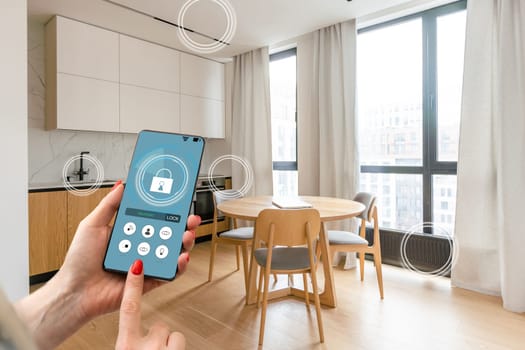 Hand of woman holding smartphone in blurred kitchen with double exposure of smart home interface. Concept of automation