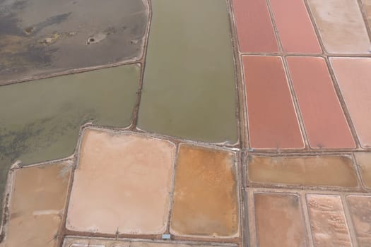 Top view of Salt evaporation ponds filled from ocean salt crystals can be harvested as water dries up.