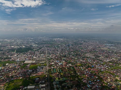 Aerial view of Medan city with residential areas and houses. Sumatra, Indonesia.