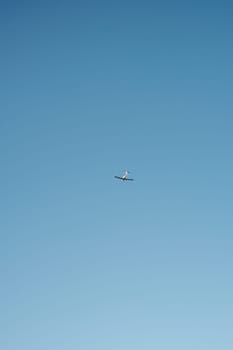 Jet Soaring Through Blue Sky